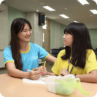 Samsung Dream Class mentor and mentee smiling while looking at each other