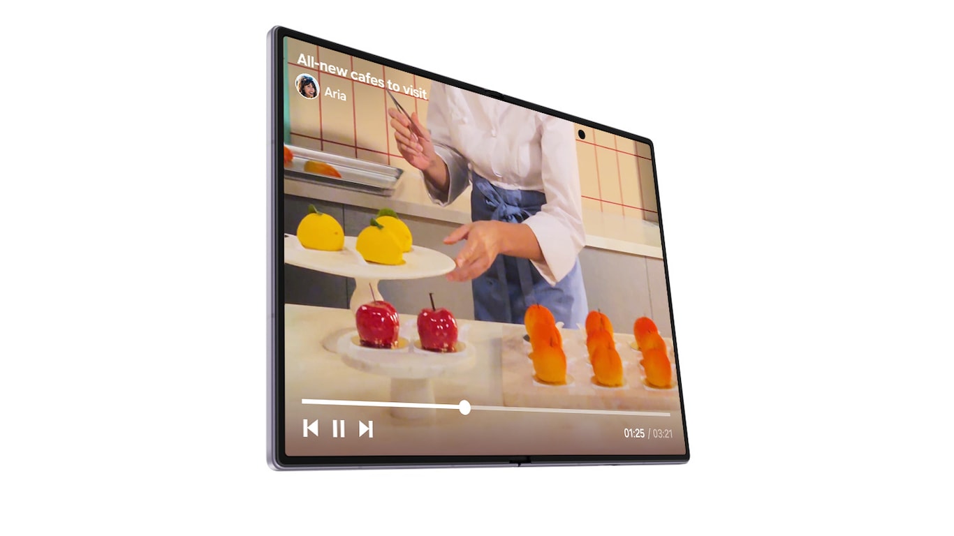 Galaxy Z Fold8 berwarna Lavender yang dalam keadaan terlipat terlihat dari layar sampulnya yang menampilkan sebuah postingan media sosial tentang toko kue. Geser ke bawah pada layar sampul untuk melihat lebih banyak postingan media sosial tentang kue. Adegan close-up pada Galaxy Z Fold8 saat perangkat tersebut dibuka untuk memutar video pada postingan media sosial terakhir di layar utama yang luas.